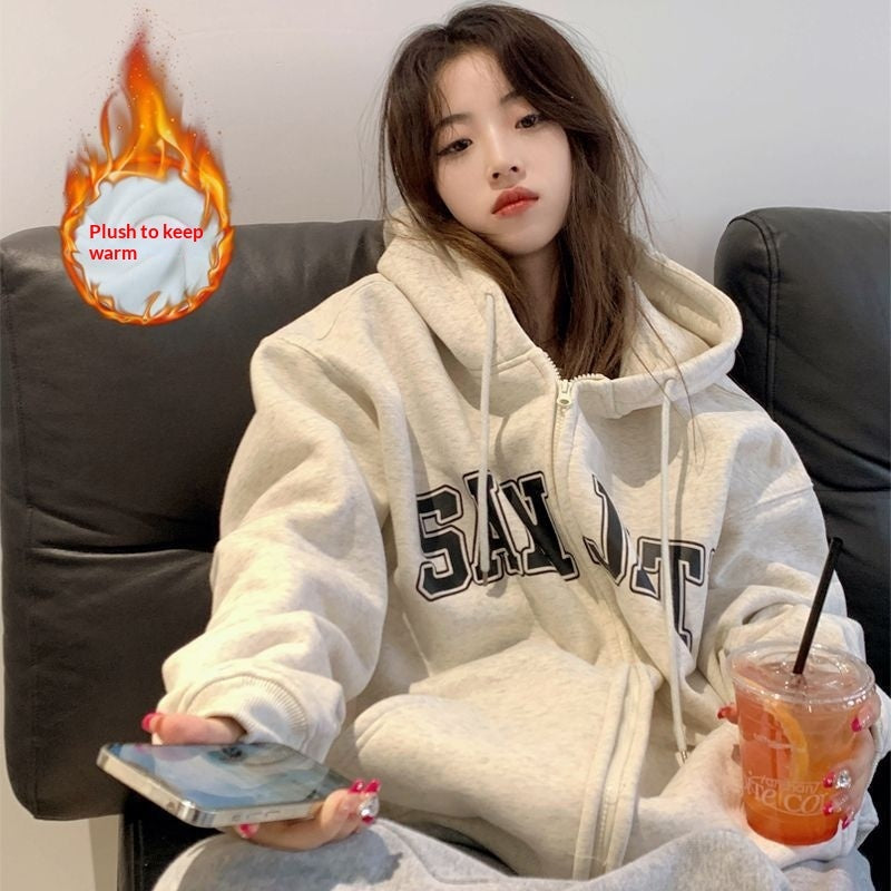 Model wearing gray Zip-up Loose Casual-Style Couple Hoodies, holding phone and iced tea.