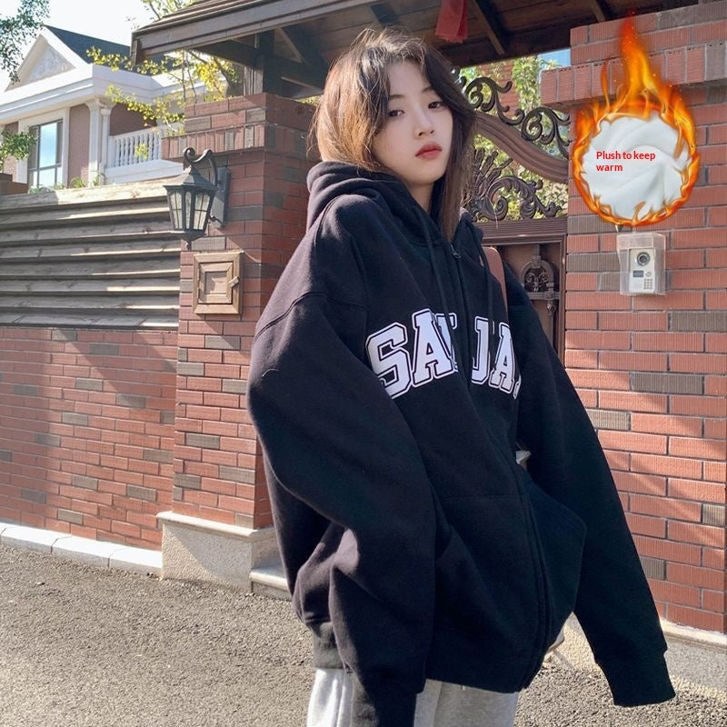 Model wearing black zip-up loose casual hoodie with SAJA letters print, from the couple hoodies line.